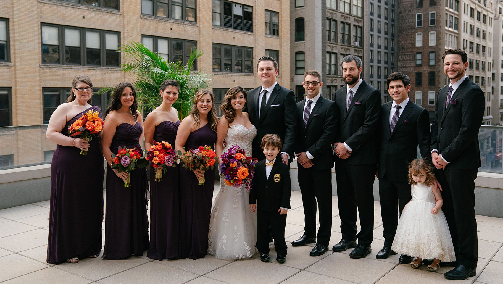 April and Daniel with their bridesmaids and groomsmen and two young children
