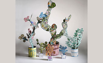 Taylor Mckimens art piece with 3 plants made from paper and wire